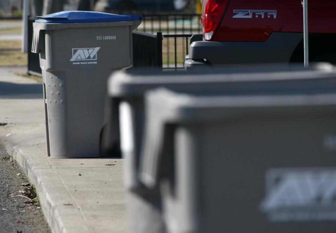 Recycle and regular trash cans line Norris Drive in the Mayfair area of Fresno.