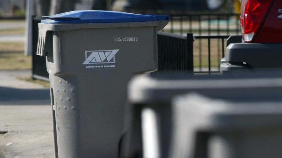 Recycle and regular trash cans line Norris Drive in the Mayfair area of Fresno.