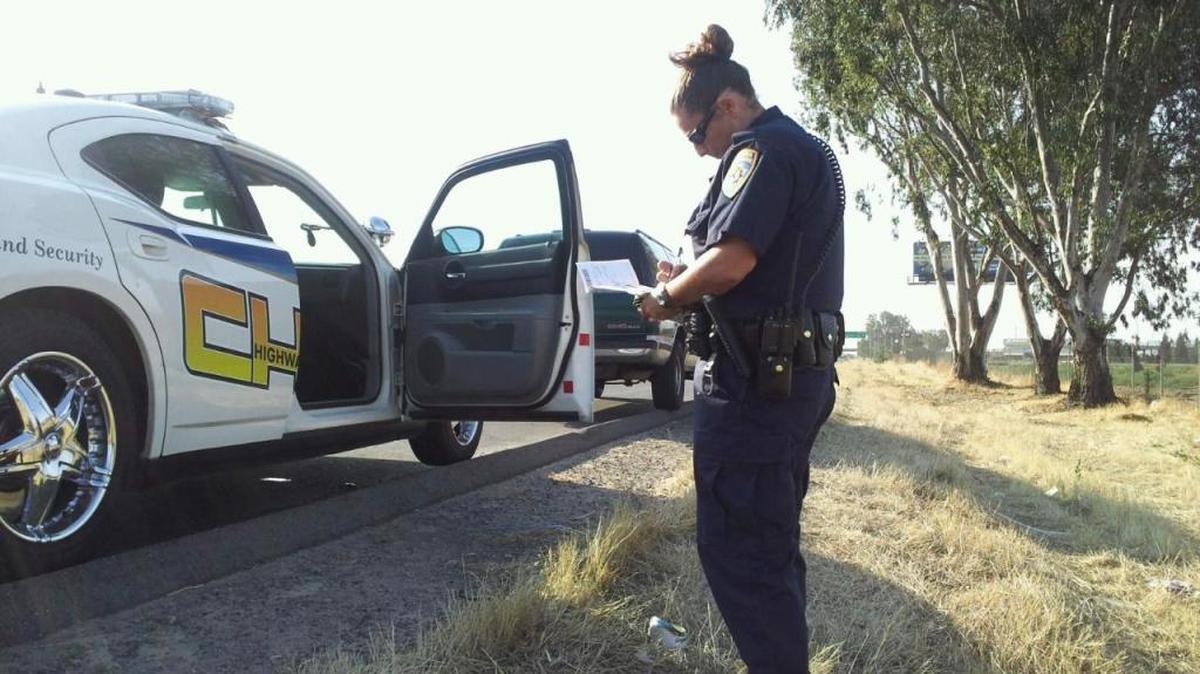 CHP officer Traci Gallian writes a ticket during a recent stop on a motorist.
