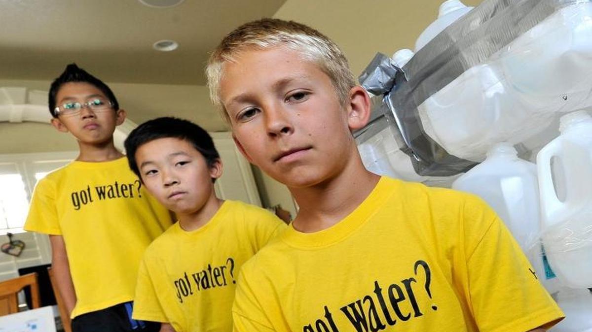
A group of Riverview Elementary sixth-graders stepped up to do their part in conserving water with an app they designed to help city of Fresno water customers track their water usage. From left: Evan Murai, Daniel Shin and Corbin Beaty. The 80 empty water jugs represent the indoor water usage for one person per day in Fresno. 
