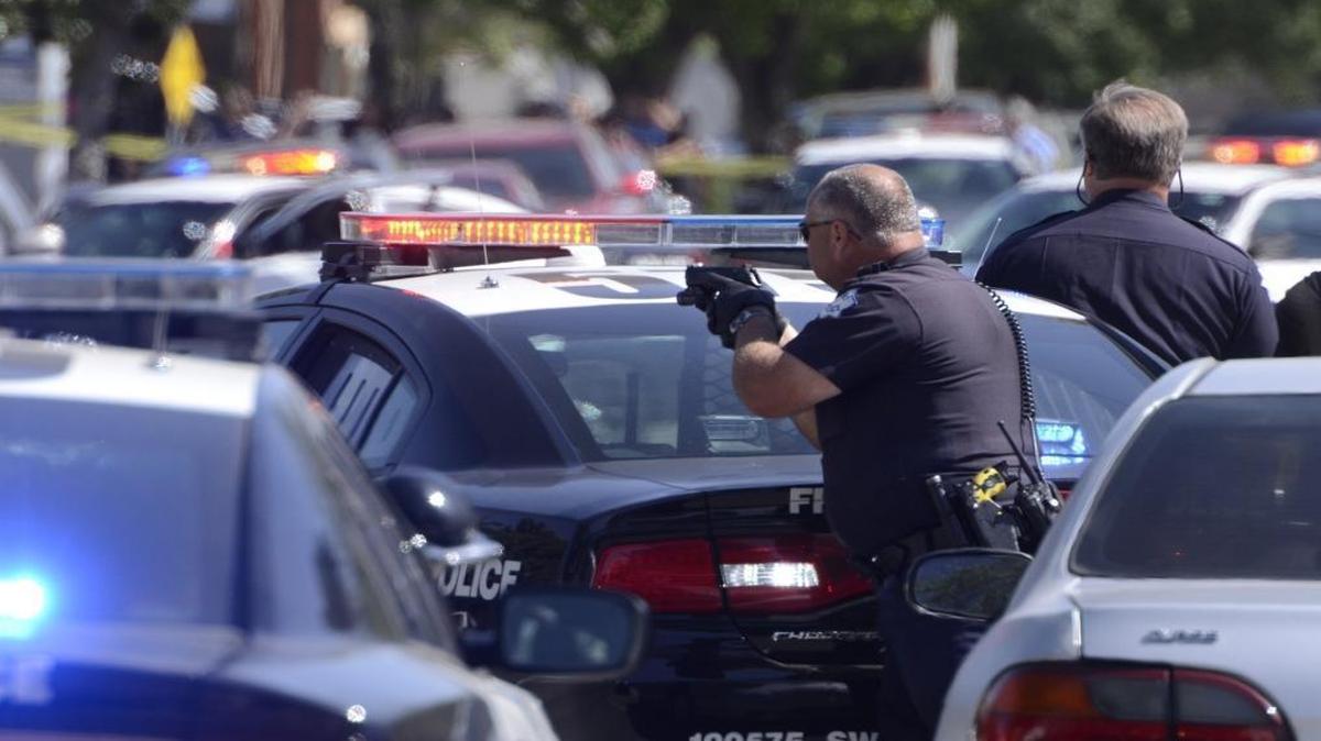 Fresno police swarm the scene of a shooting in downtown Fresno last year. A new report finds low morale among the city’s patrol officers.