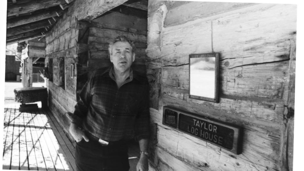 
Ronald Bluford Taylor Jr., stands outside the Taylor cabin in Oakhurst.  The log house was built by his great-grandfather, William Bluford Taylor, an original co-settler of Fresno Flats, now known as Oakhurst.
