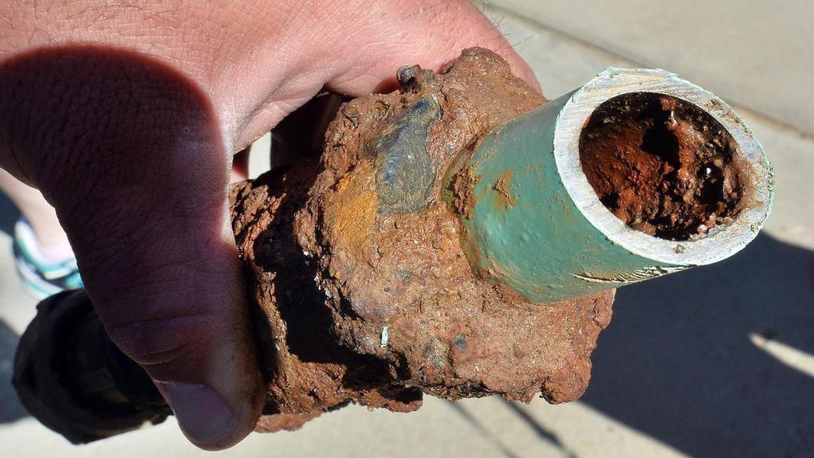 Rust and corrosion are visible on the inside of a cut-out section of service line between the water meter and a northeast Fresno home in which the owner has seen discolored water dating to 2004.