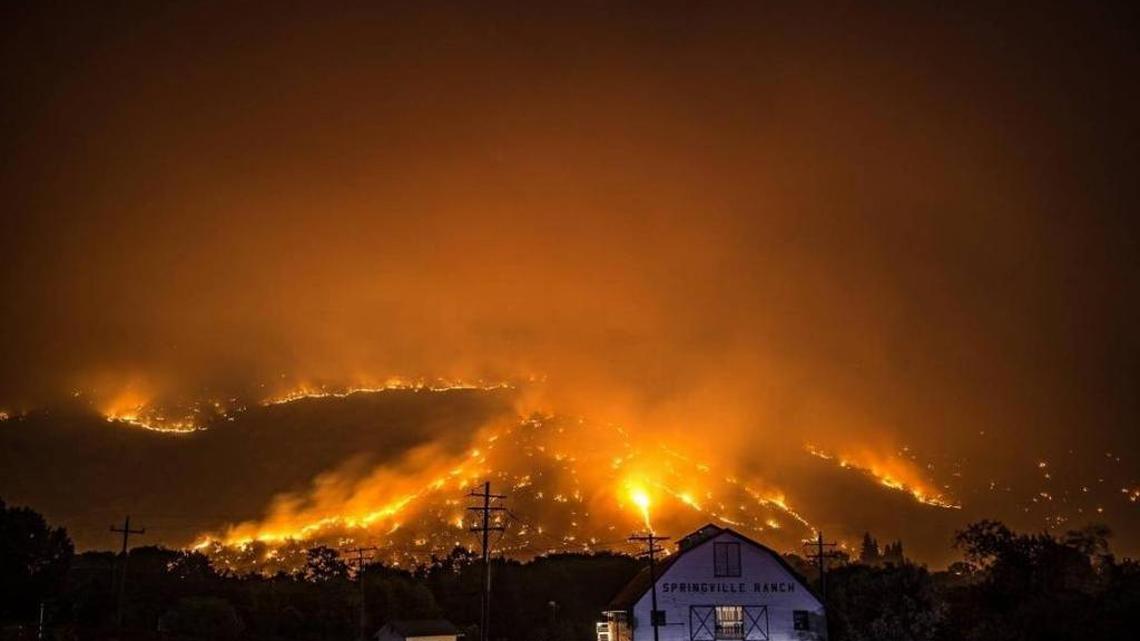 The Pier Fire burns behind the Springville Ranch barn.