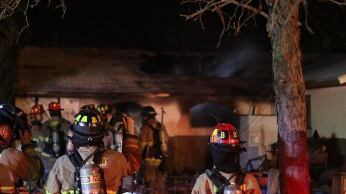 Firefighters inspect the damage to a home in the 300 block of West Florence Avenue in west Fresno on Tuesday, Dec. 12.