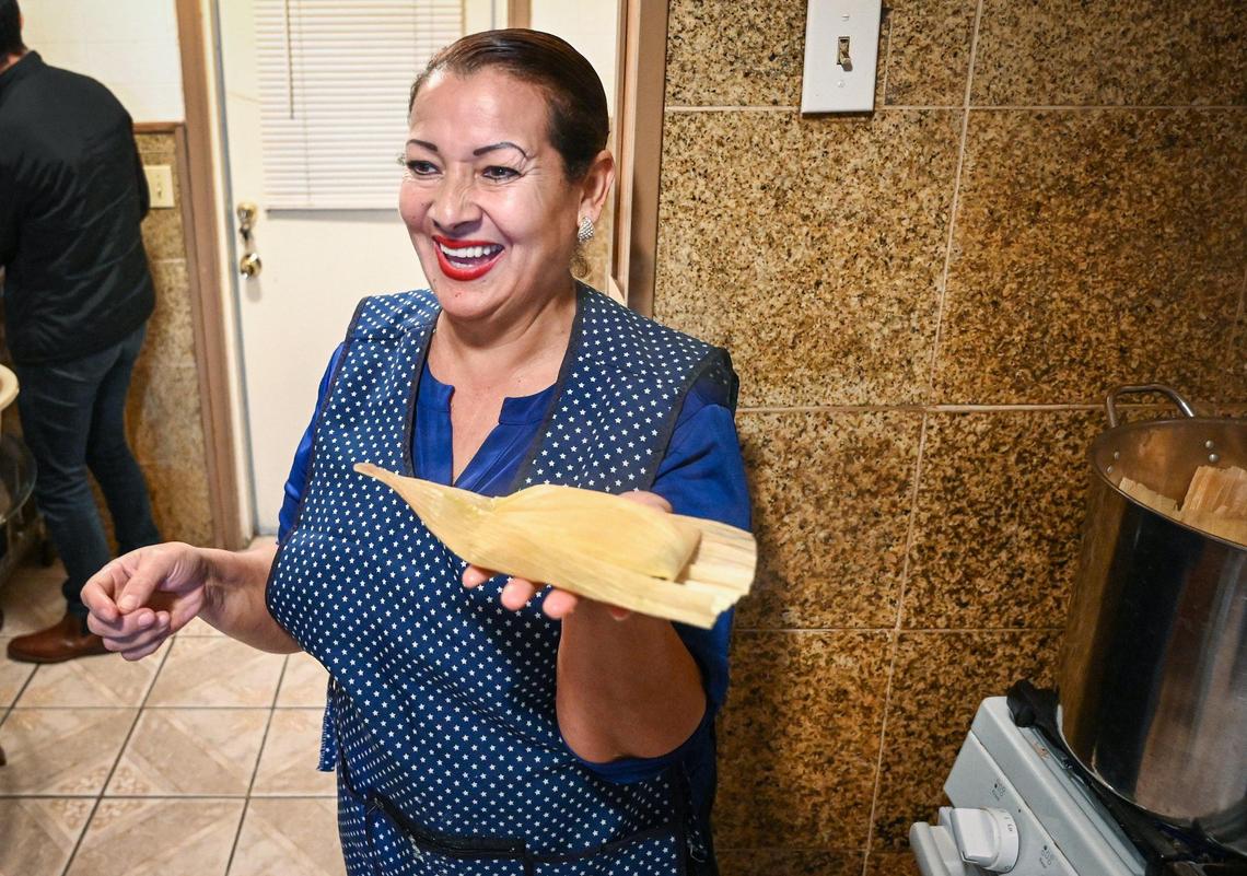 Cristina Leon smiles while making tamales in her son’s kitchen in Fresno on Friday, Dec. 17, 2021. Ruben Vasquez has been making TikTok videos of his mother’s cooking, generating a following of more than 55,000.