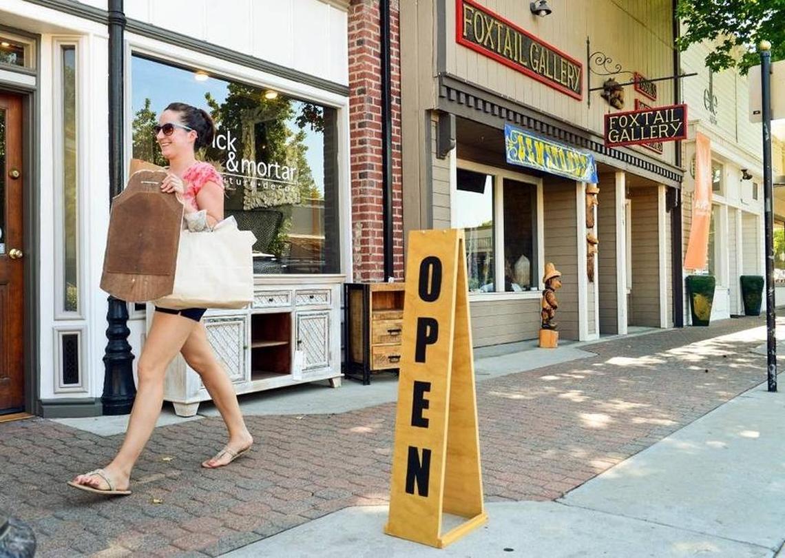 A shopper walks past storefronts in Old Town Clovis in 2014. The Fresno County city is among the safest and most affordable in the United States, according to GoBankingRates.
