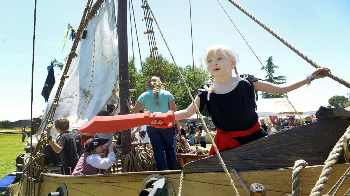 Mystina Cordua, 6, of Visalia waves her red Styrofoam saber while taking charge of the Willamina pirate ship on display at the Fresno Pirate Festival at Kearney Park Sunday. The Willamina is a copy of a 16th century Dutch yacht built by Wayne “Grandpa Morgan” Borning, an honorary member of the Under the Black Flag combat troupe, which put the ship on display for kids at the two-day event. The 11th annual festival moved from Roeding Park due to the zoo expansion and provided spectators with food vendors, a treasure hunt, belly dancers, jugglers, magicians, singers, and a pirate “skool” for kids.