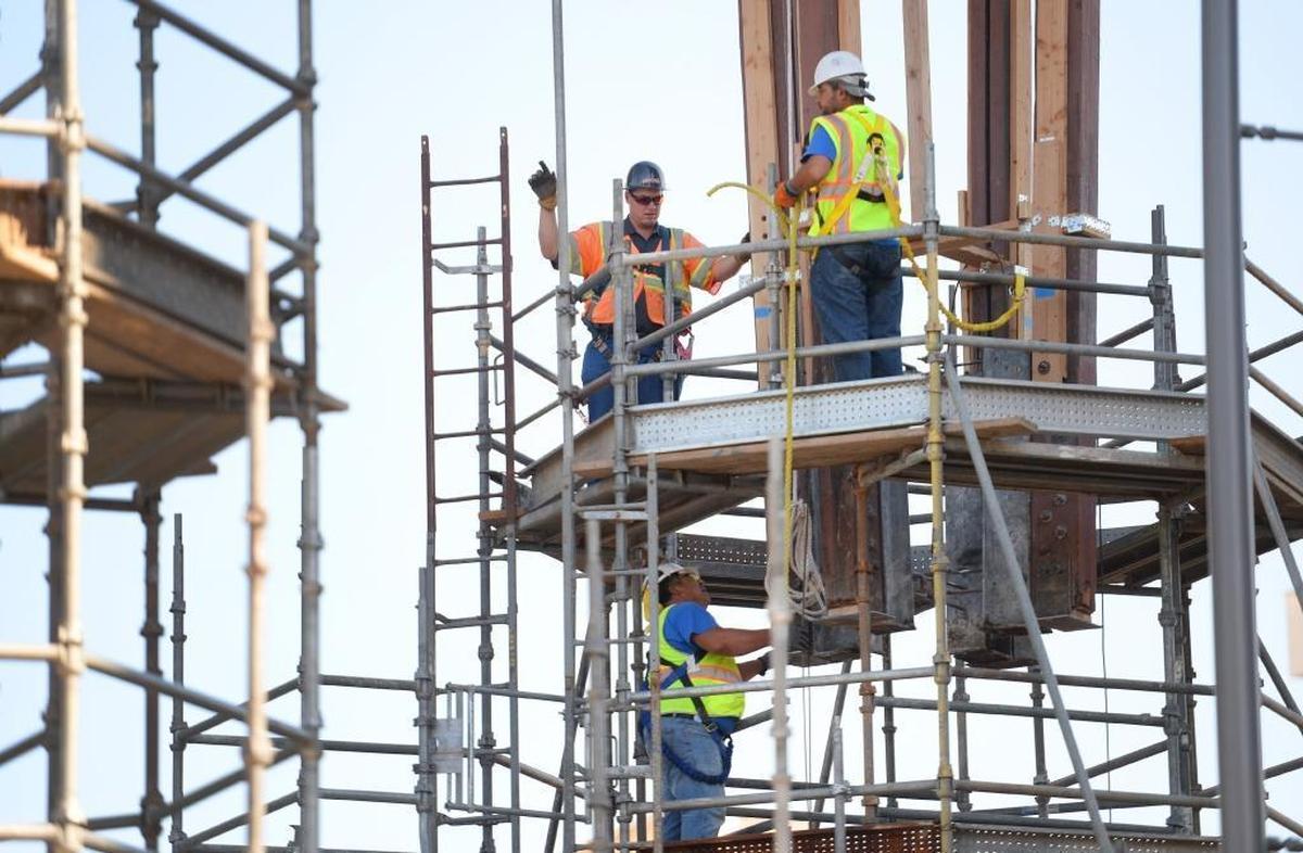 Workers raise the Fulton Mall clock tower from its scaffolding before moving it about 30 feet to the southwest to its new position on the corner of Fulton and Mariposa streets on Tuesday, July 18, 2017. Restoration work on the clock tower, first put in place in Fulton Mall in 1964, will begin at its new spot. Work is continuing to open the mall to vehicle traffic.