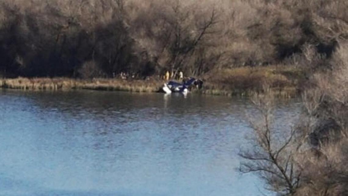 Rescuers reach the single-engine aircraft that crashed shortly after takeoff from Sierra Sky Park in northwest Fresno Monday, Dec. 26, 2016.