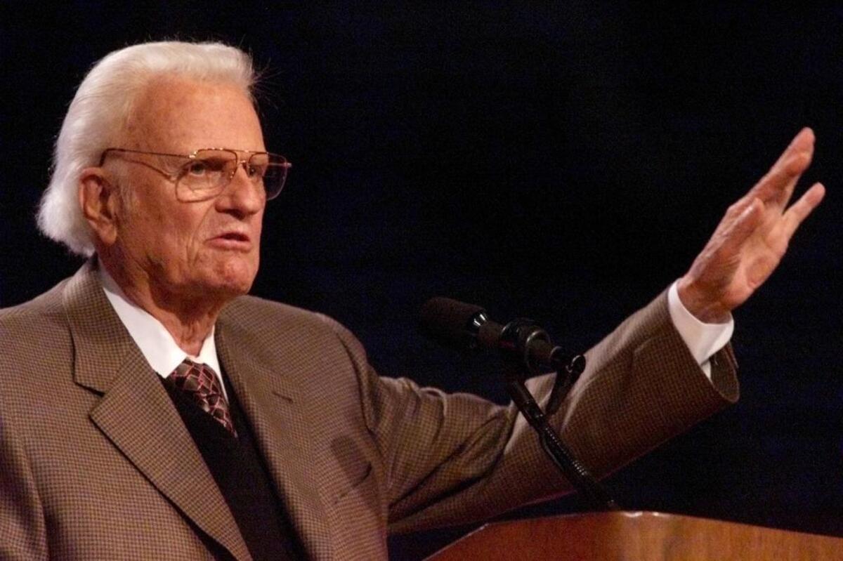 Billy Graham speaks at the podium Oct. 14, 2001, for the last night of a four-day crusade at Fresno’s Bulldog Stadium. The Rev. Graham died Feb. 21, 2019 at age 99.