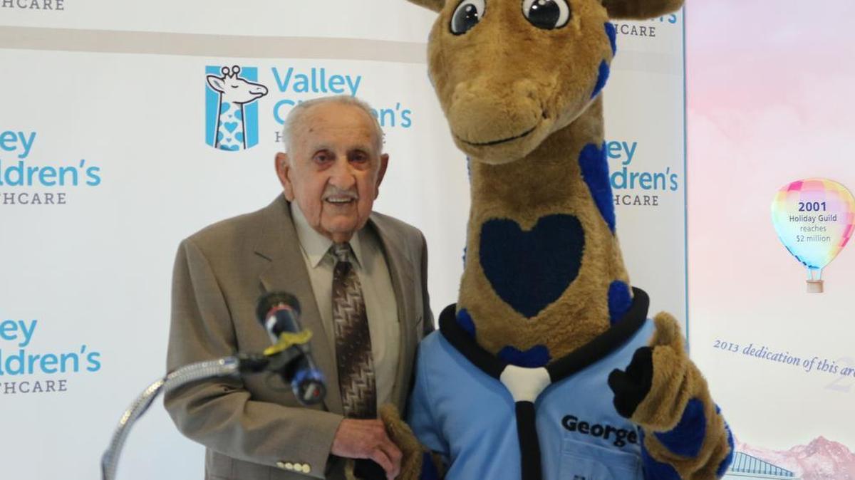
Manuel Mancebo Jr. and “George,” Valley Children’s mascot.
