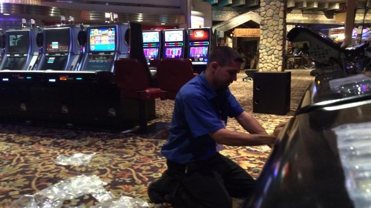 
Steven Sheehan, a field service technician for Aristocrat, a gaming machine company, works on a new “Sons of Anarchy” machine at Chukchansi Gold Resort & Casino. 
