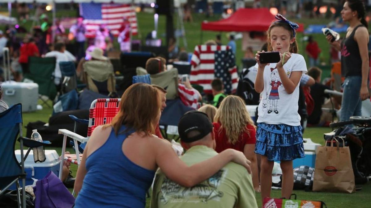 In a 2013 file photo, Samantha Spaulding takes a picture of her mom and dad before the Clovis Freedom Fest, a Fourth of July celebration and fireworks show, at Buchanan High School.