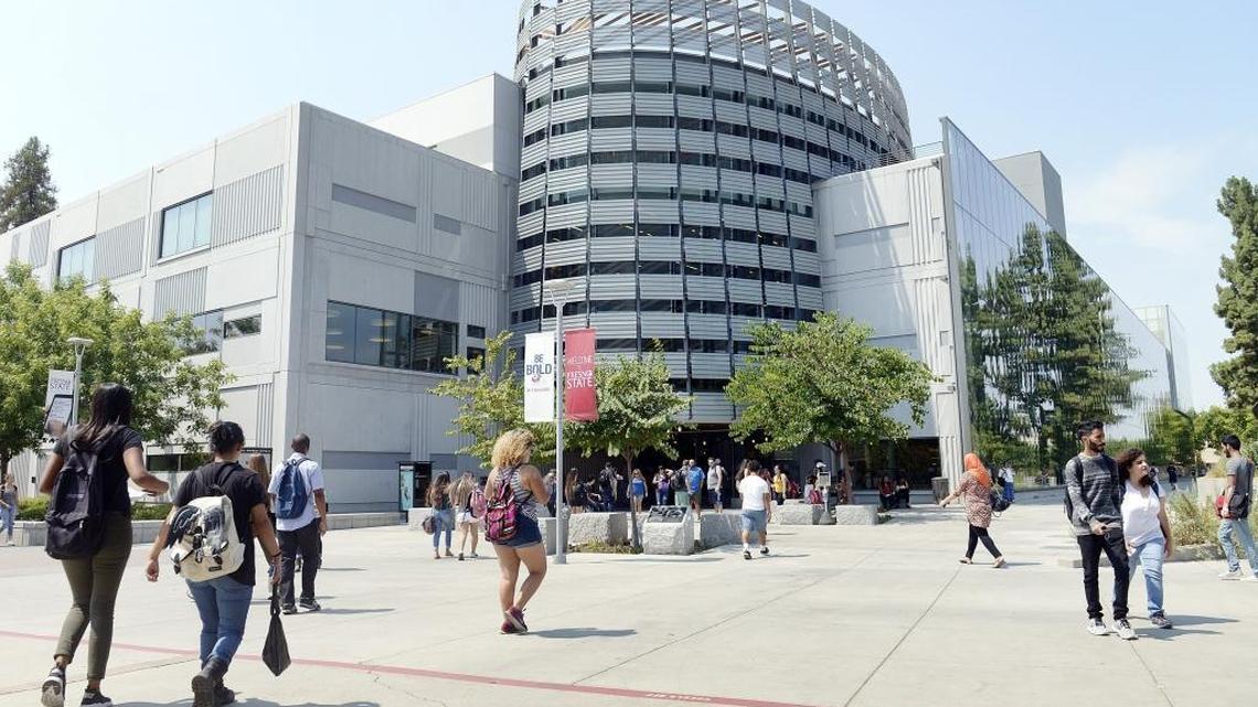 Students walk by the Madden Library at Fresno State.