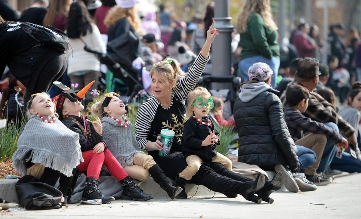 Families take in the sights at Fulton and Mariposa streets during the 88th annual Downtown Fresno Christmas Parade on Saturday, Dec. 2, 2017.