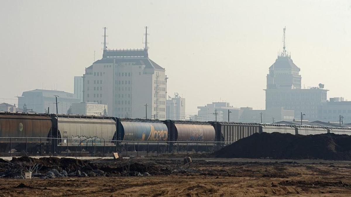 A train moves in front of the downtown Fresno skyline where thick haze filled the air on an otherwise sunny day Friday, Nov. 24, 2017.