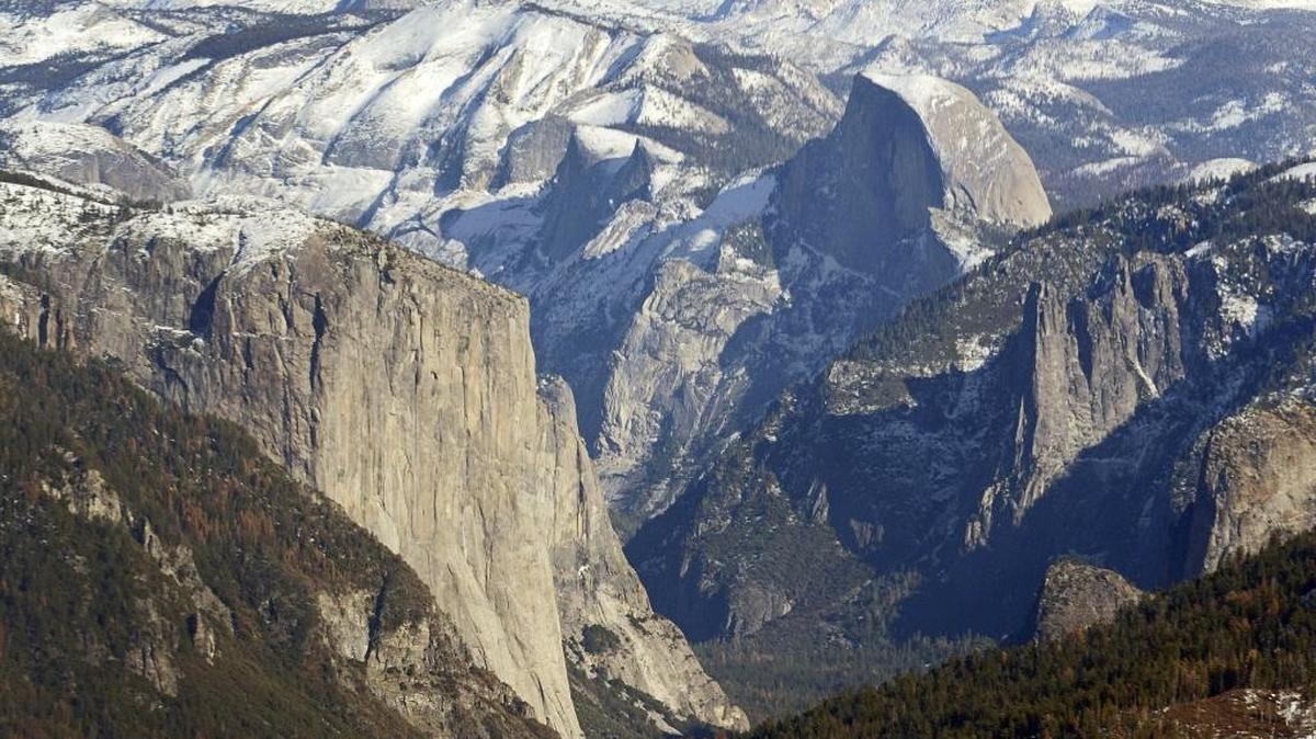 El Capitan, left, and Half Dome are seen in Yosemite Valley from the perspective of a helicopter looking east toward the Sierra Nevada mountains Tuesday.