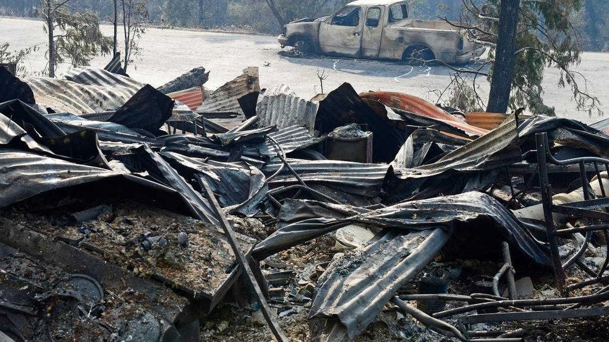 A burned pickup truck sits in front of the destroyed Kings Canyon Lodge in Kings Canyon National Park in this August 2015 file photo. The historic lodge burned to the ground in the Rough fire.