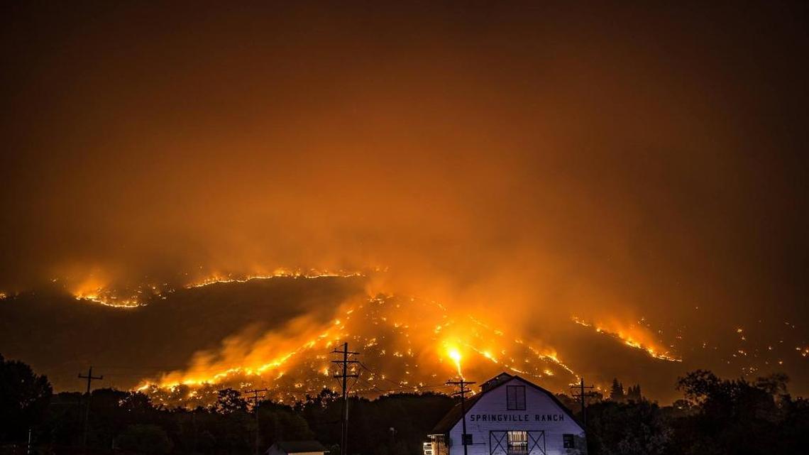 The Pier Fire burns behind the Springville Ranch barn.