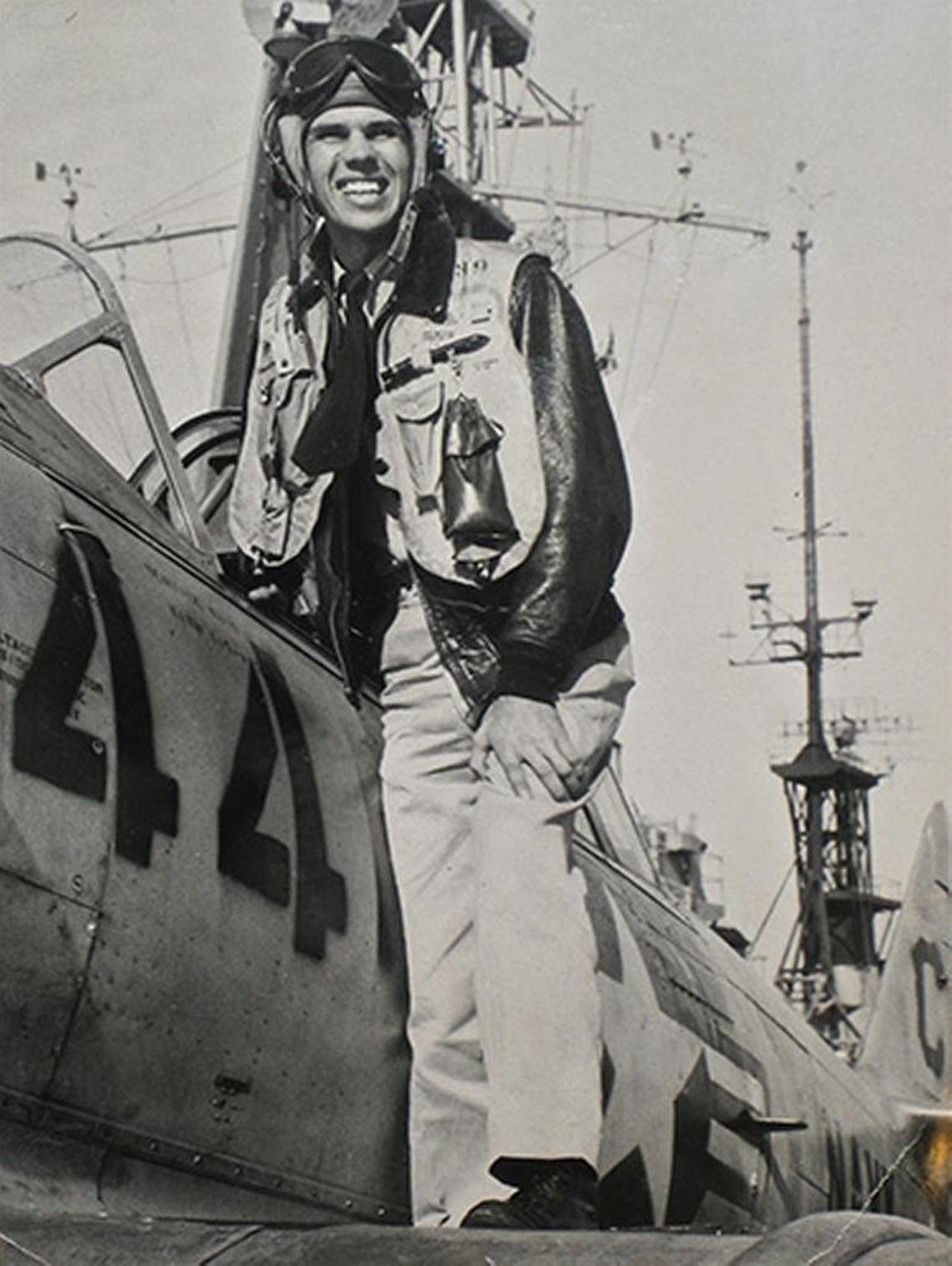 Robert “Bob” Hansen beside a plane in the U.S Navy Reserve.