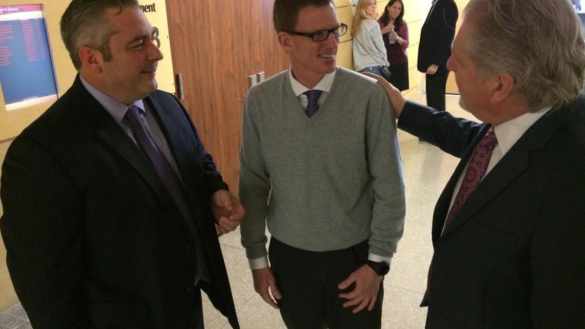 Dr. Michael J. Moffett, center, chats with his lawyers, Travis Stokes, left, and Charles Doerksen after testifying on Jan. 28, 2016.