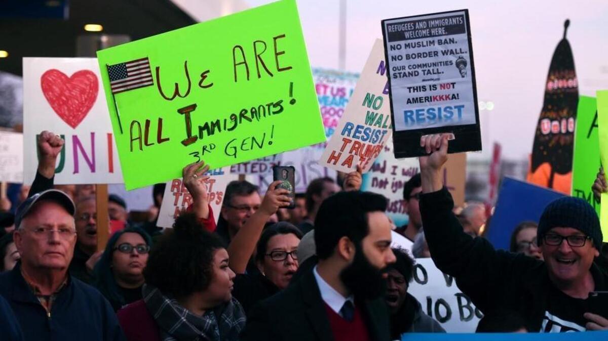 Hundreds of people hold signs in front of Fresno Yosemite International Airport during a protest Sunday evening, Jan. 29, 2017 in Fresno, Calif. Fresno’s history is built on migration. This personal account shows how immigrants shaped the city through work, culture and bilingual education.
