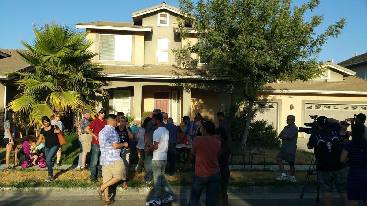 Northwest Fresno residents gather outside of a vacant home that was to house a sex offender. The Department of State Hospitals withdrew the placement in the wake of protests, but the residents are afraid they’ll place him in a different vacant house in the area.