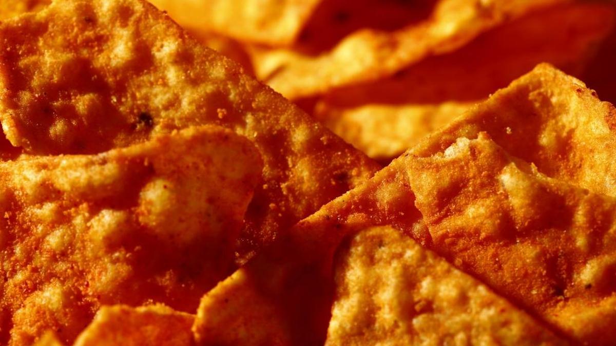 This Sept. 26, 2014 photo shows Nacho Cheese flavored Doritos in Philadelphia. Artificial and natural flavors have become ubiquitous terms on food labels, helping create vivid tastes that would otherwise be lost in mass production. As the science behind them advances, however, some are calling for greater transparency about their safety and ingredients.