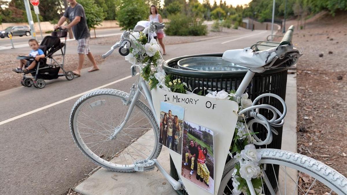 A “ghost bike” is decorated with photos of Patrick TeNyenhuis, who was killed while riding his bicycle in Clovis in April, along the “Ride of Silence” route that honors the memories of cyclists killed by automobiles, on Wednesday, May 18, 2016, in Fresno.