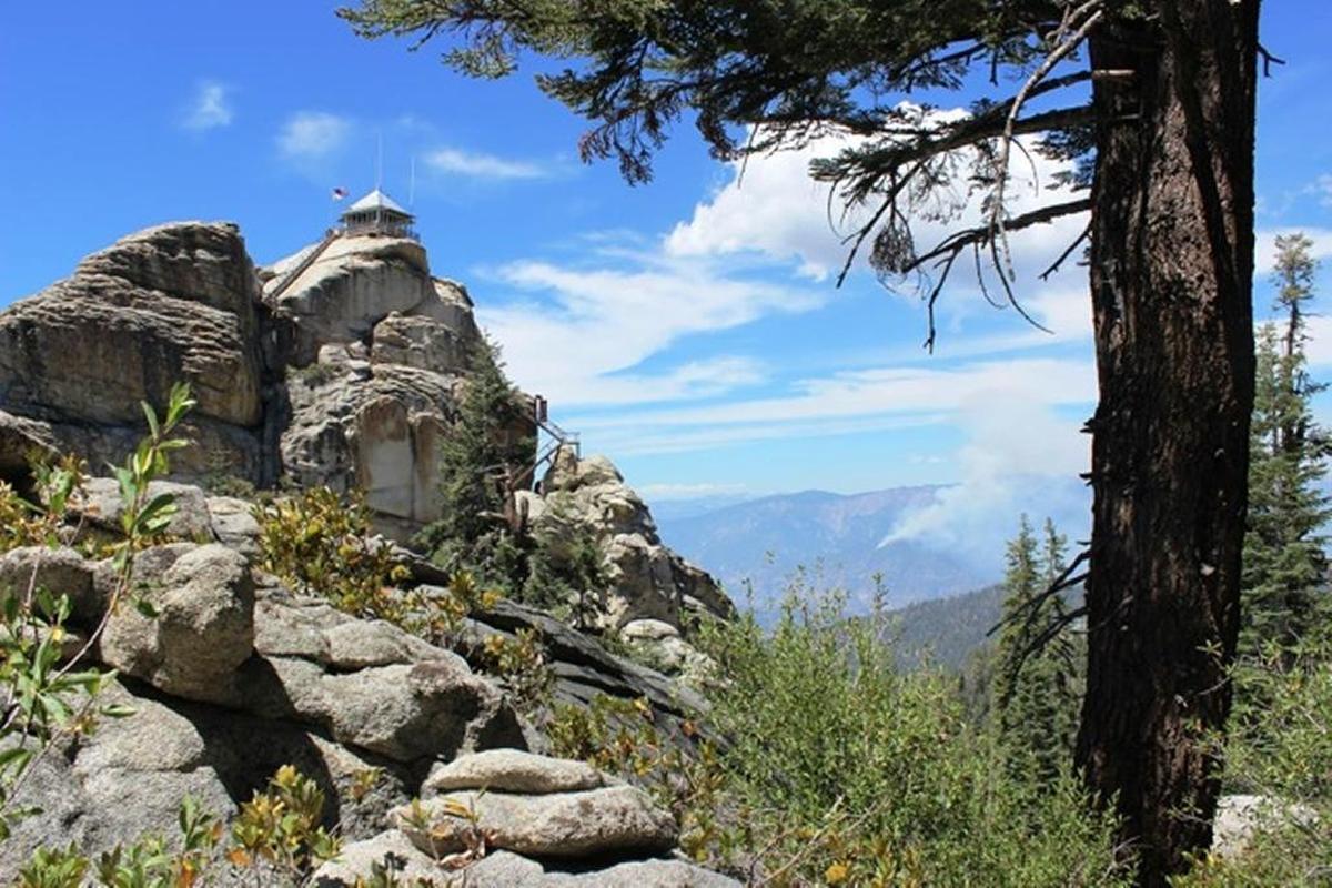 The Buck Rock Lookout in Giant Sequoia National Monument with smoke in the background from the Rough Fire. The lookout spotted the wildfire in 2015.