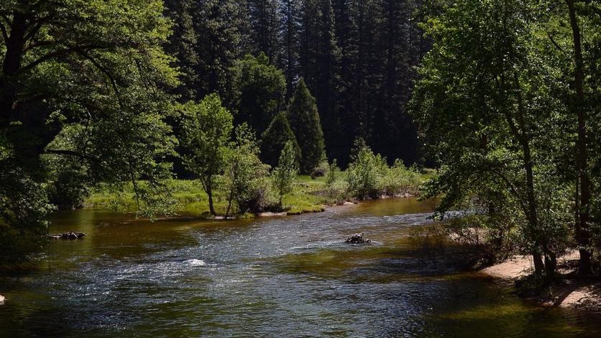 Rafters float along the Merced River in Yosemite National Park with Half Dome in the distance in this June 2014. The river is running stronger now thanks to runoff from melting snow. A search is underway to find an Oakhurst man who went rafting on Monday and then separated from his group.