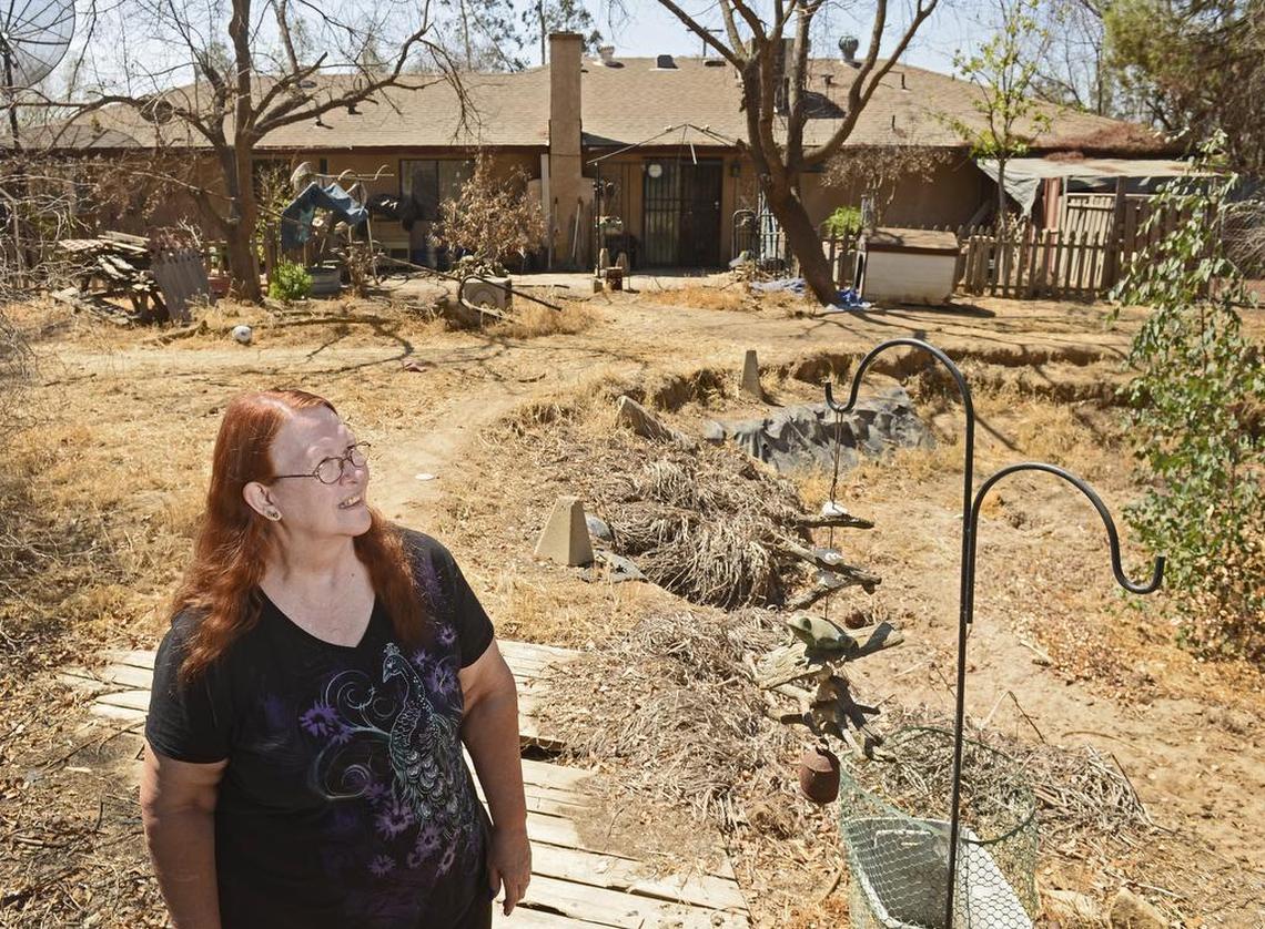 Sheryl Haflich of Madera stands in her yard in 2014. “It makes me angry, very angry, because we could have sold our house for so much more,” said Sheryl Haflich, who with her husband Bobby were stuck in limbo for several years before the California High-Speed Rail Authority was legally able to purchase their home north of Madera in the fall of 2015. “We could have had a better start for retirement, and we could have gotten out when we wanted to instead of when they decided to.”