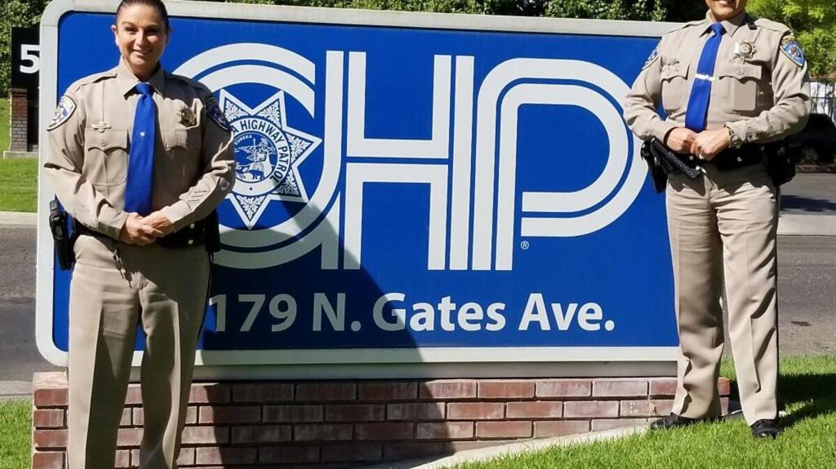 CHP Officer Traci Gallian, left, joins Officer Graciella Santillan James outside the CHP headquarters in Fresno. James writes that she first wanted to become a CHP officer when a young girl.
