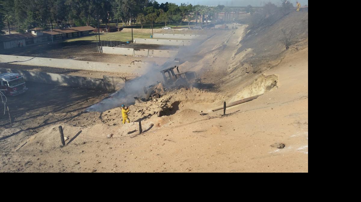 
An investigator combs the area where a Pacific Gas & Electric Co. pipeline ruptured April 17, 2015 at the Fresno Sheriff’s Foundation shooting range. The explosion left one man dead and 12 injured. A report for the California Public Utilities Commission released Monday, July 6, 2015 concludes that the front-end loader visible in the photo caused the rupture.
