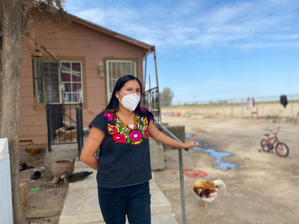 Laura García, 33, stands outside her Raisin City home. Her eldest daughter, a student at Raisin City Elementary School, tested positive for COVID-19 in August.