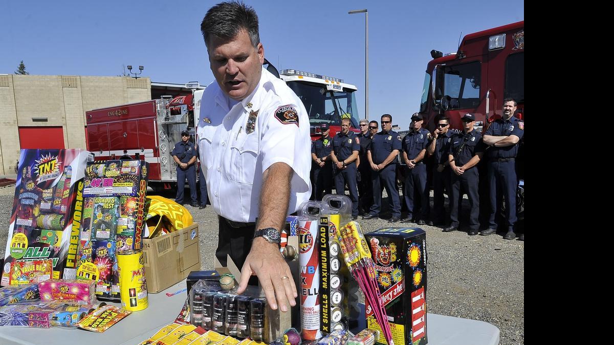 
Clovis Fire Department Deputy Chief John Binaski shows illegal fireworks at right, with legal fireworks at left, at the news conference to demonstrate the dangers of fireworks at the Clovis Fire Department Training Center, Thursday morning.
