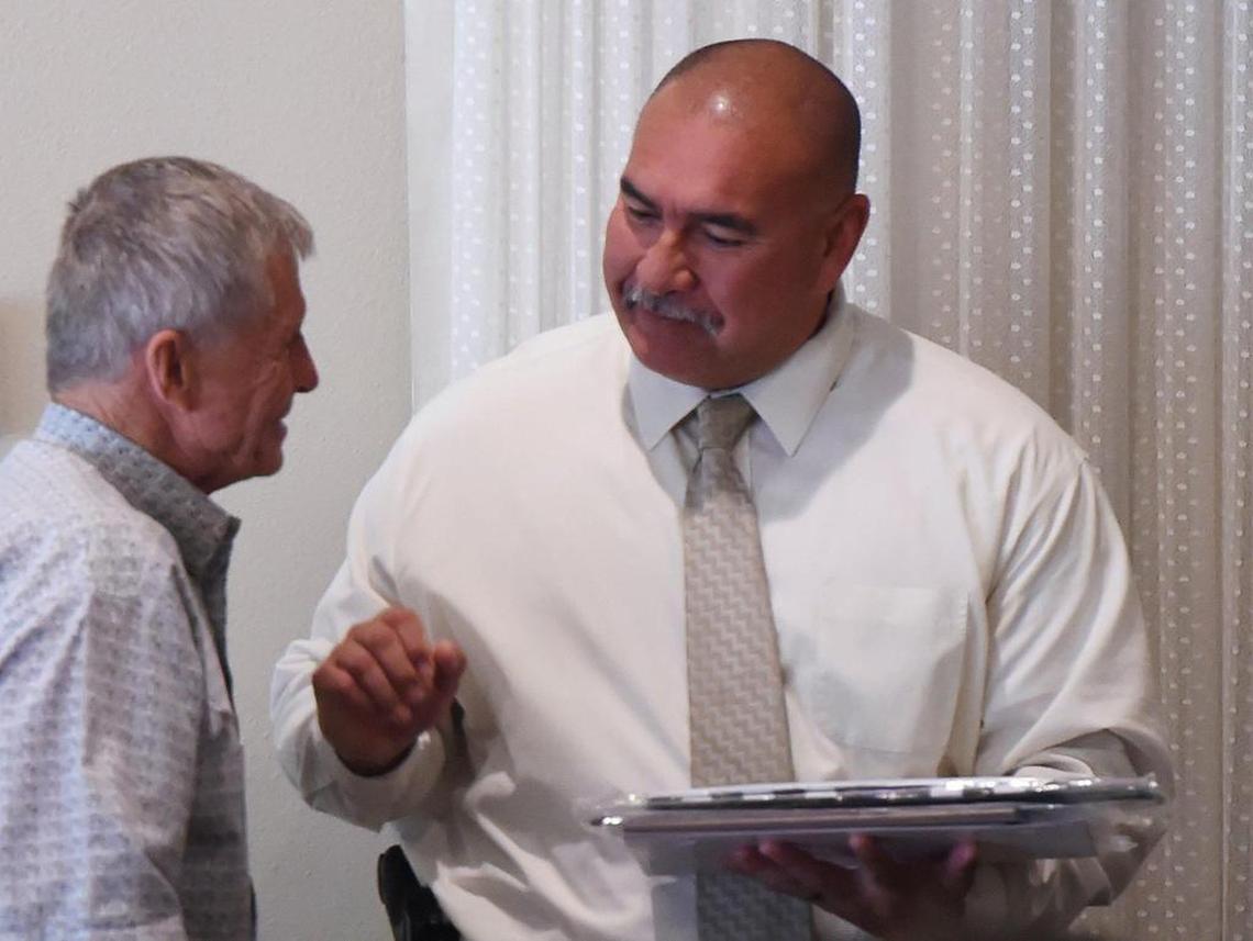 Fresno County Sheriff’s Office Detective Jesse Gloria, right, receives a plaque from Exchange Club of Fresno chairperson Steve Sommer, left, at the Exchange Club’s Top Cop luncheon honoring three law enforcement officers Thursday, May 6, 2019 in Fresno.