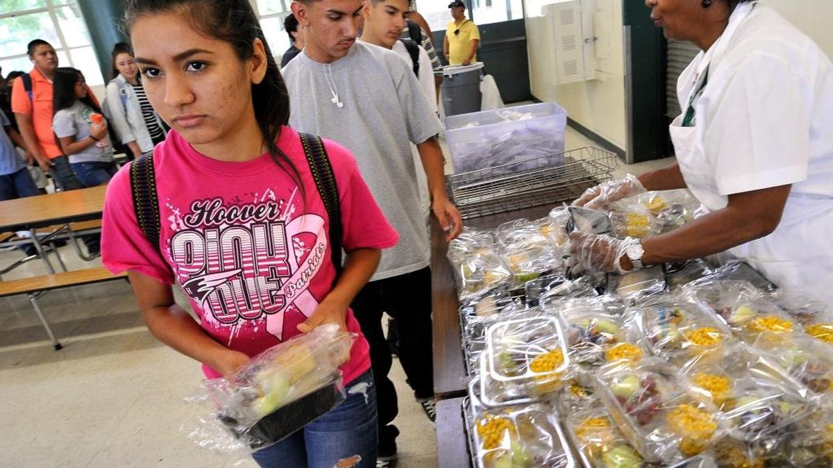 Roosevelt High School junior Yaritzi Chavez picks up her lunch of a burrito, corn and fruit, during the school’s summer meals program last year.