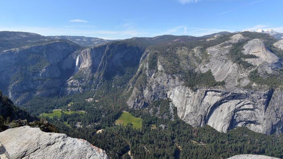A view of the Upper and Lower Yosemite Falls and the valley floor from Glacier Point at Yosemite National Park.