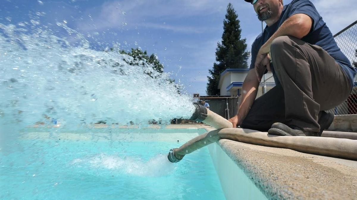 Greg Mastrantuono of the city's Park and Recreation department fills the Pinedale Community Center pool from a fire hydrant in this 2012 file photo.
