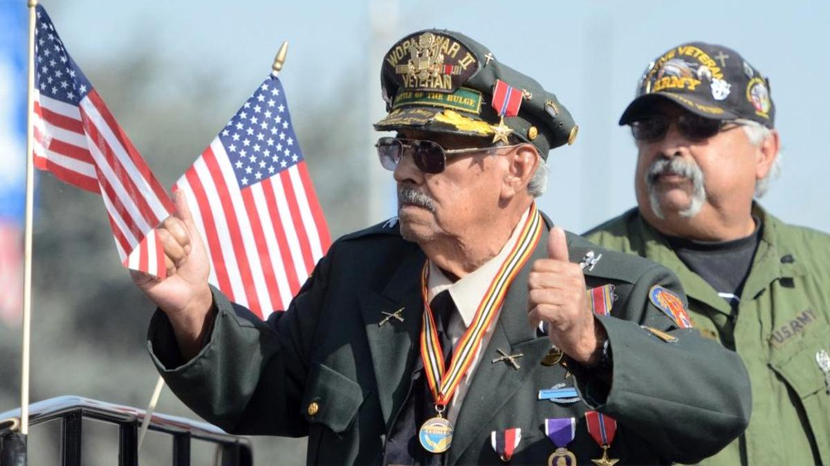 WW II veteran Juan Cedillo gives the crowd a thumbs up as he rides during the 2013 Fresno Veterans Day Parade. Cedillo fought in the Battle of the Bulge, which was the largest land battle of World War II involving U.S. forces in Europe.