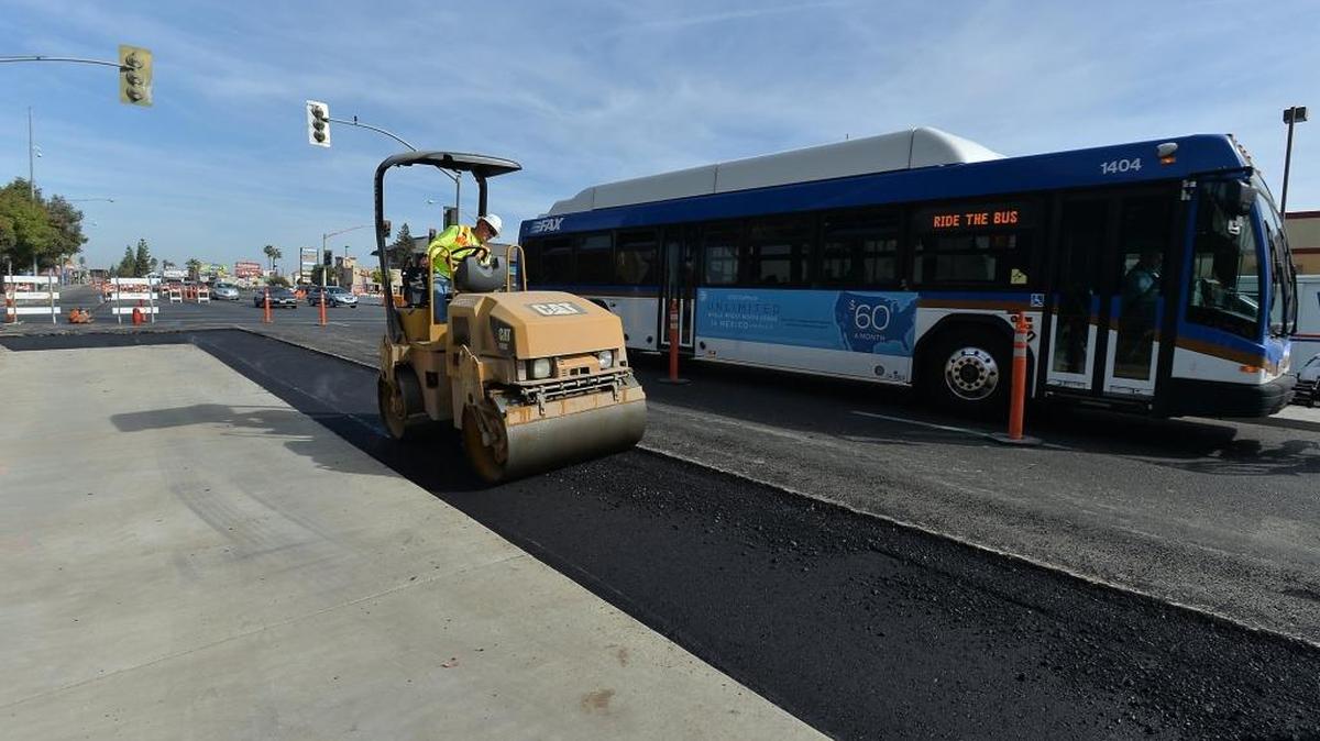 Paving crews work on installing new bus pads for the bus rapid transit project at the corner of Ashlan and Blackstone avenues on Friday, Oct. 7, 2016, in Fresno.