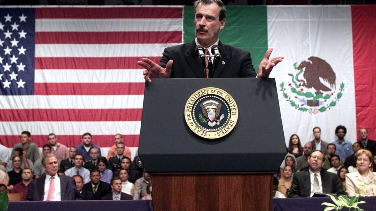 Mexican President Vicente Fox speaks as President George W. Bush looks on during a visit to Savage Hall at University of Toledo, in Toledo, Ohio, in 2001.
