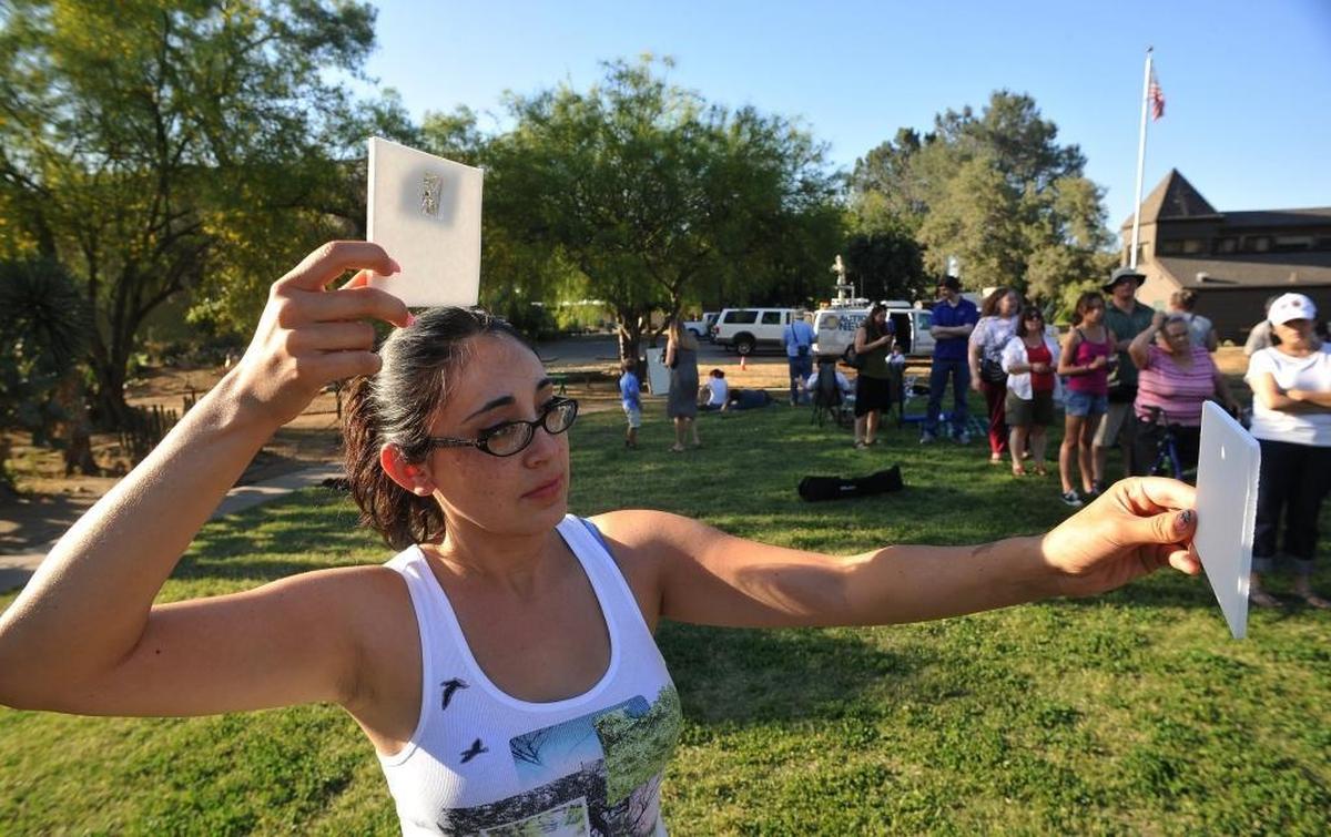 Cici Anderson uses a “pinhole projector” to view a May 2012 solar eclipse on a piece of paper at the Discover Center in Fresno.