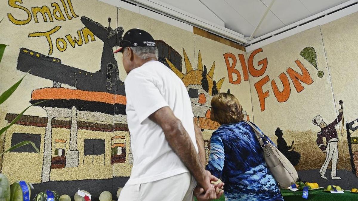 
A couple stops to look at the horticulture murals, made of beans, seeds and nuts, at the Caruthers District Fair on Wednesday.
