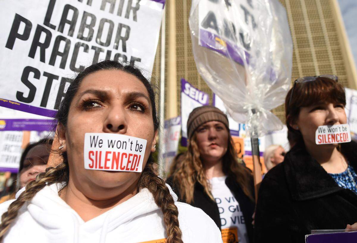 Judicial assistant Maria Duran, left, joins dozens of other protesting court workers during a press conference Friday afternoon, Jan. 18, 2019.