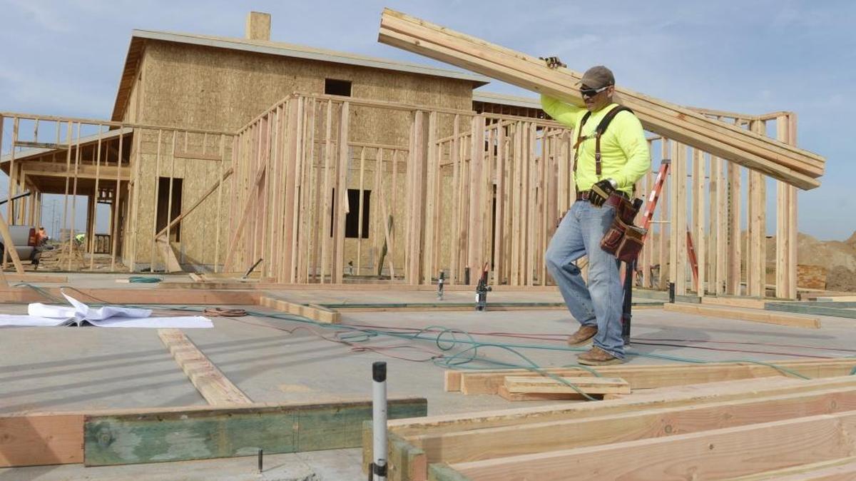 Humberto Guzman of Garcia Construction carries lumber while beginning construction on a home in the Gary McDonald Homes tract at Chestnut and Copper in the Copper River Ranch area in February 2016. The Fresno City Council is considering a water fees that would add over $4,000 to the cost of a new home.