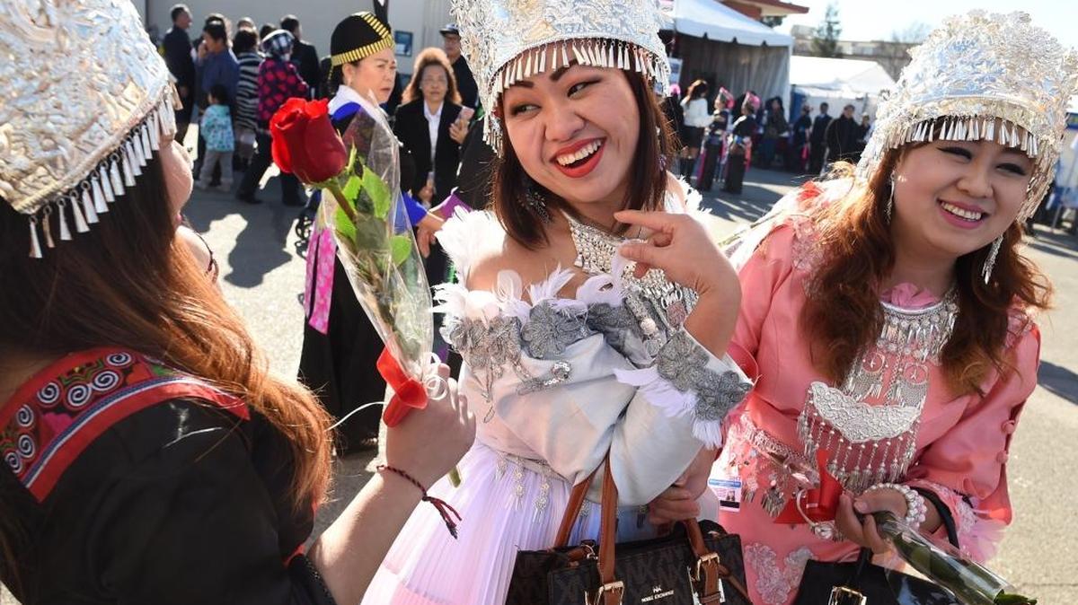 Snow Lee, center, jokes with friends Yeng Xiong, left, and Youa Lee (her sister), right, during the Hmong International New Year, Monday afternoon Dec. 26, 2016.