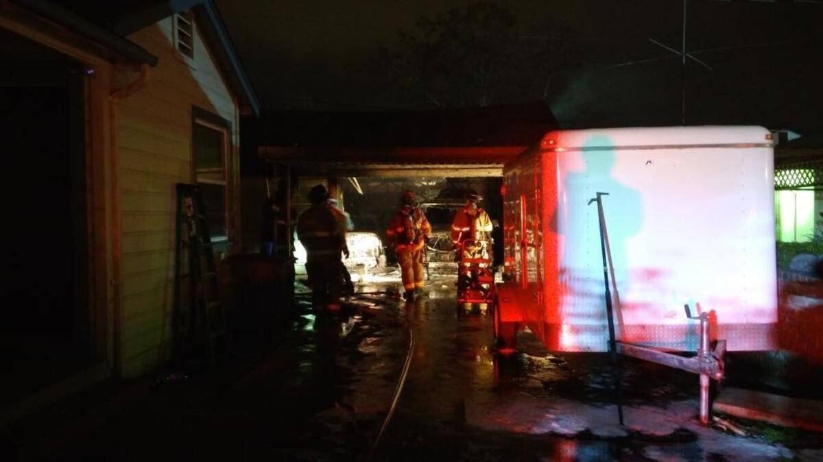 Fresno firefighters inspect a detached garage that burned Sunday, Jan. 1, 2017, in southeast Fresno.